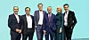 Six formally dressed professionals standing in a row before a turquoise background From left to right, the image shows Infineon executives: Alexander Gorski, Chief Operations Officer; Dr Sven Schneider, Chief Financial Officer; Jochen Hanebeck, Chief Executive Officer; Dr Herbert Diess, Chairman of the Supervisory Board; Elke Reichart, Chief Digital and Sustainability Officer; Andreas Urschitz, Chief Marketing Officer.