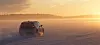 Volkswagen ID.3 electric car driving on a snowy road at sunset