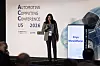 Speaker on stage at Automotive Computing Conference US 2026 with sponsor logos on backdrop.
