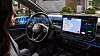 Driver in Volkswagen car using voice-activated controls on a wide touchscreen display