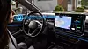 Driver in Volkswagen car using voice-activated controls on a wide touchscreen display