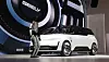 Geely concept car displayed on stage next to a humanoid robot at a tech event