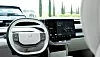 Front interior of a Volvo electric car with steering wheel, digital display and touchscreen.