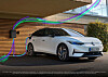 White electric hatchback parked outside a modern building with colourful light trails in the foreground.