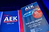 Blue-lit AEK event screens showing the AEK logo, a farewell message and conference details.