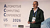 Man speaking on stage in front of an Automotive Computing Conference US 2026 backdrop.