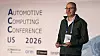 Man speaking on stage in front of an Automotive Computing Conference US 2026 backdrop.