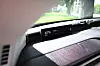Car interior with a digital display showing battery level and sunlight across the dashboard.