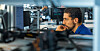 Man at a desk looking at a computer screen in an office.