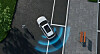 Self-driving car on a city street with blue detection arcs around it.