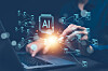 Hands using a laptop with glowing artificial intelligence symbols and digital data graphics overlaying the screen.